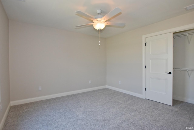 unfurnished bedroom featuring a closet, light colored carpet, and ceiling fan