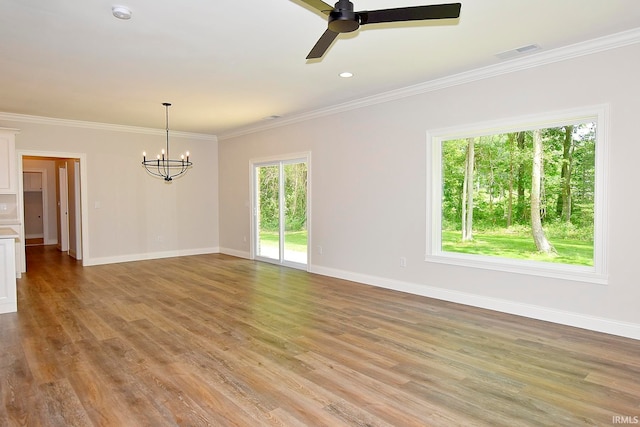 empty room featuring crown molding, ceiling fan with notable chandelier, and light hardwood / wood-style flooring