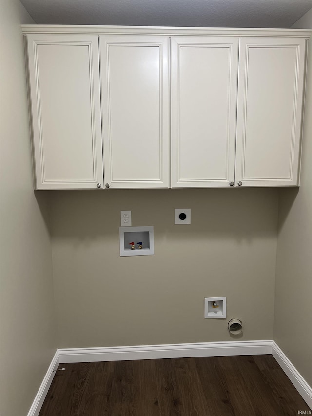 washroom featuring cabinets, hookup for a washing machine, dark hardwood / wood-style floors, and hookup for an electric dryer