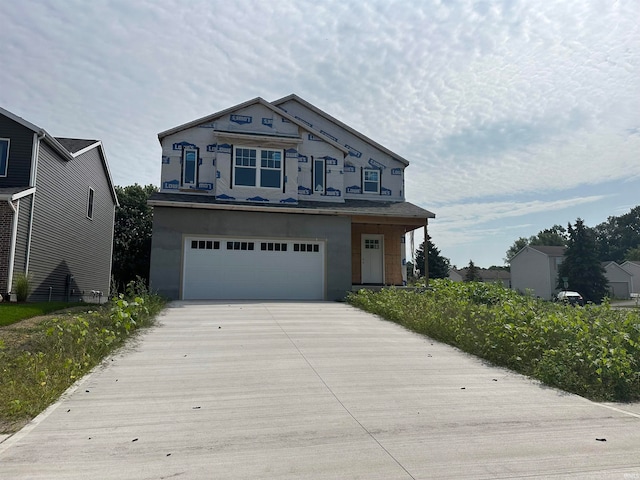 1114 Beacon Dr, Mishawaka, IN 46544 - view of front of home featuring an attached garage, driveway, and stucco siding