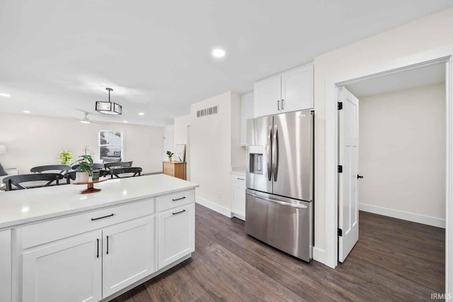 1114 Beacon Dr, Mishawaka, IN 46544 - kitchen with visible vents, stainless steel fridge, light countertops, white cabinetry, and dark wood-type flooring