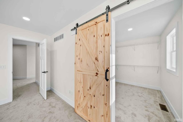 1114 Beacon Dr, Mishawaka, IN 46544 - interior space with light colored carpet, baseboards, visible vents, and a barn door