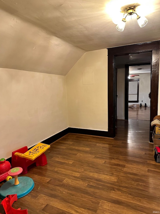 bonus room featuring dark wood-type flooring and lofted ceiling