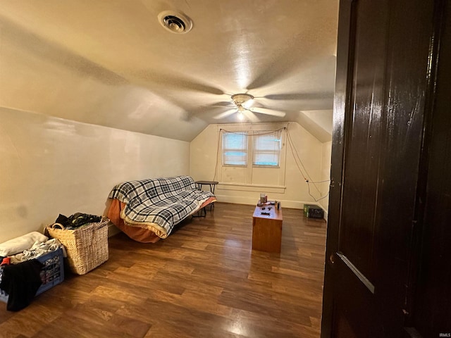 bedroom with vaulted ceiling, ceiling fan, and dark hardwood / wood-style flooring