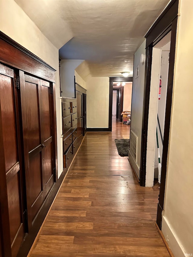 corridor with dark hardwood / wood-style floors