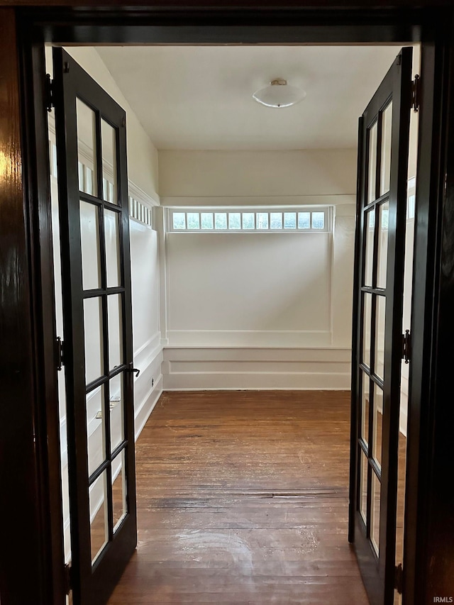 interior space with dark hardwood / wood-style flooring and french doors