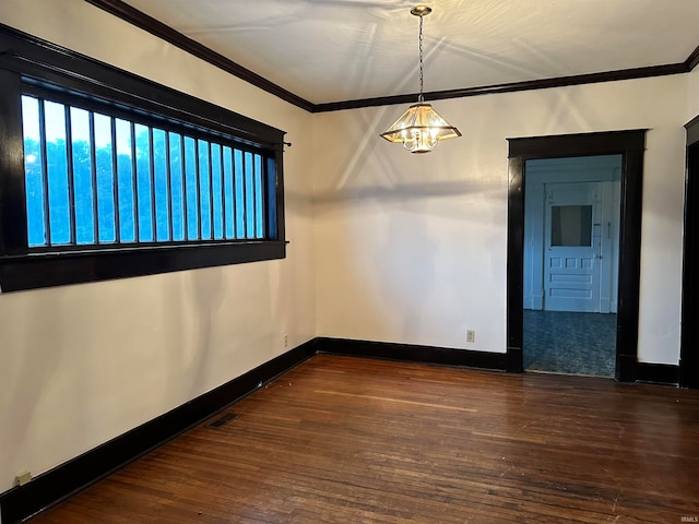 empty room with ornamental molding and dark wood-type flooring