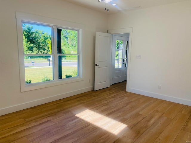 empty room with light hardwood / wood-style floors and ceiling fan