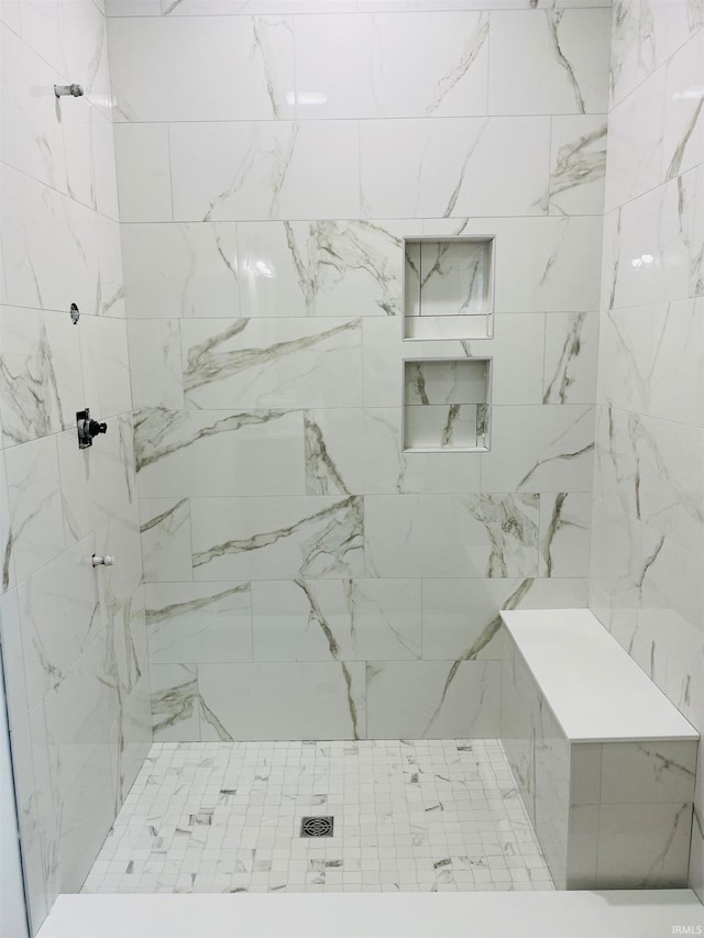 bathroom with tiled shower