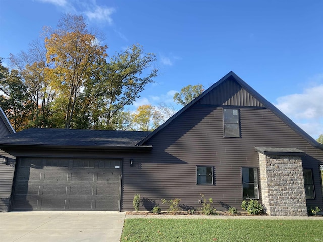 view of side of home featuring a lawn and a garage