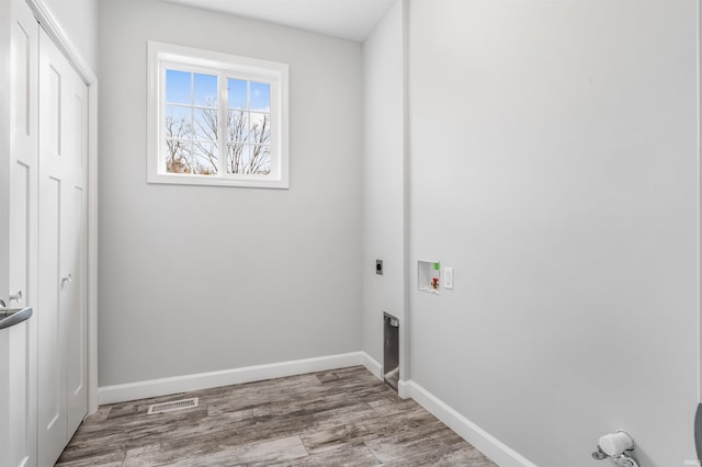 laundry area with washer hookup, light hardwood / wood-style floors, and electric dryer hookup