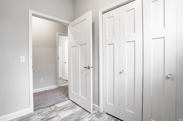 unfurnished bedroom featuring light wood-type flooring and a closet