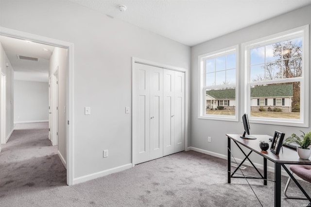 unfurnished office featuring light colored carpet