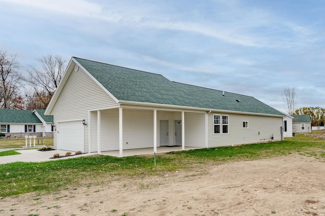 rear view of property with a garage