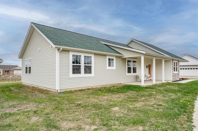 back of property with a porch and a lawn