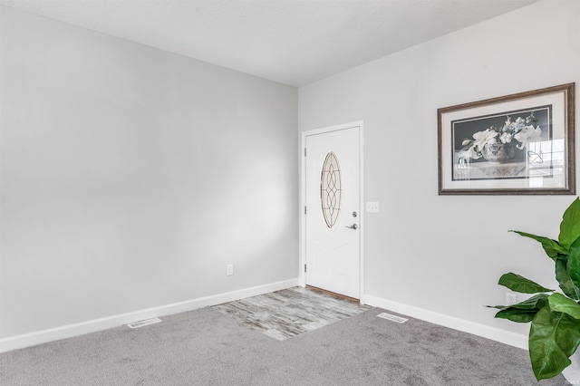 foyer featuring carpet floors