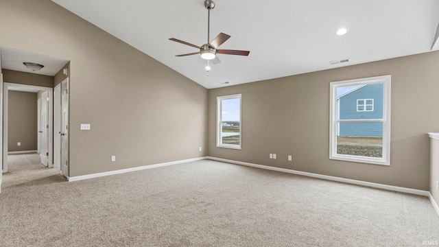 carpeted spare room featuring ceiling fan and lofted ceiling