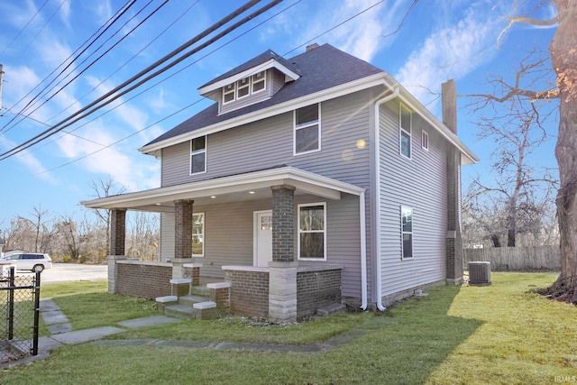 view of front facade with central AC unit, covered porch, and a front lawn