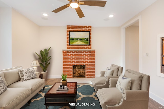 living room with hardwood / wood-style flooring, a fireplace, and ceiling fan