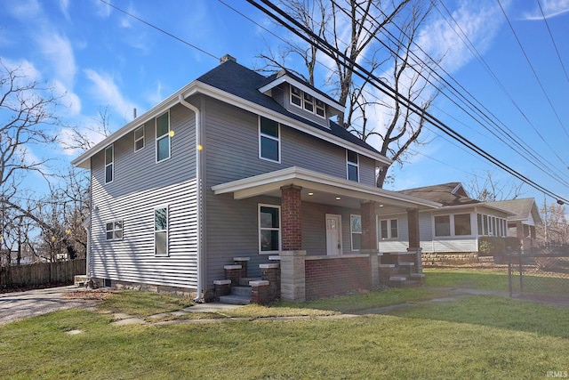 view of front of house with covered porch and a front lawn