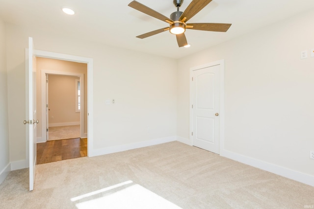 empty room featuring carpet floors and ceiling fan