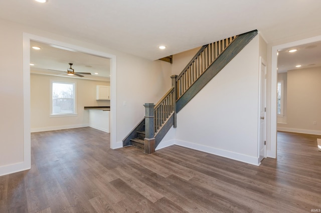 unfurnished living room with ceiling fan and dark hardwood / wood-style floors