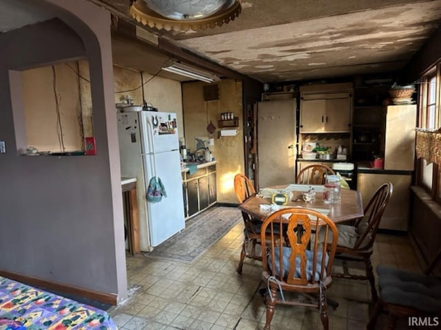 kitchen featuring white refrigerator and light tile patterned floors