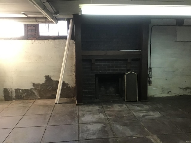 basement with a brick fireplace