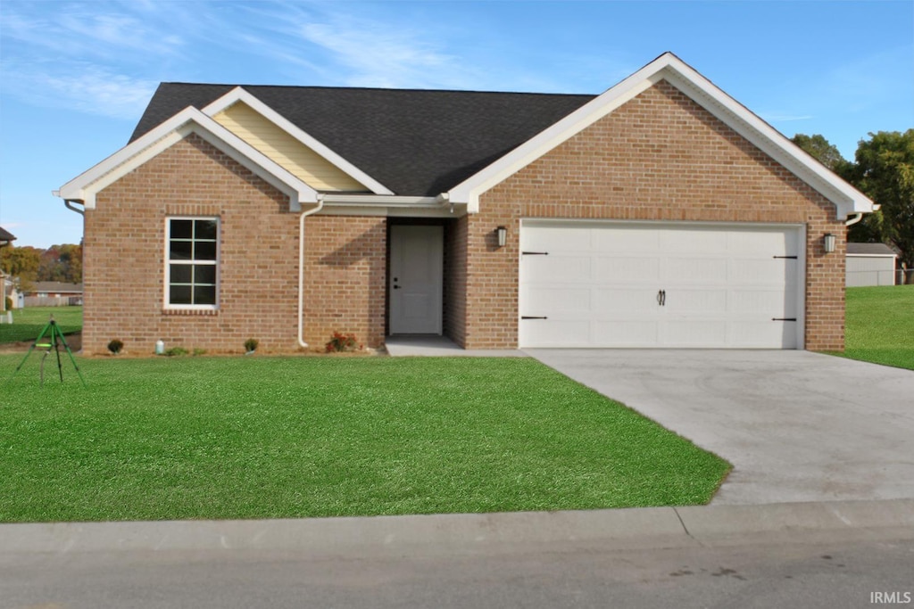 ranch-style house featuring a front lawn and a garage