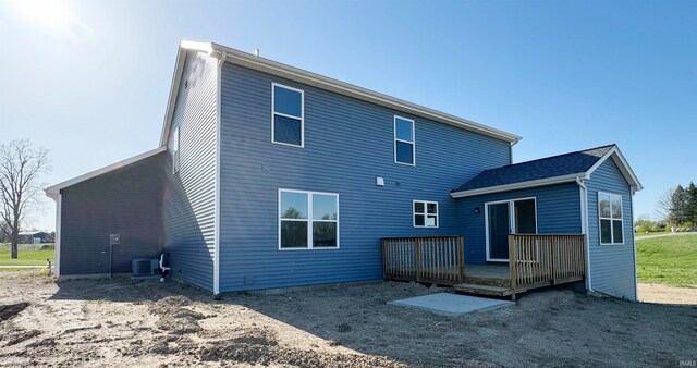 rear view of house with central AC unit and a deck