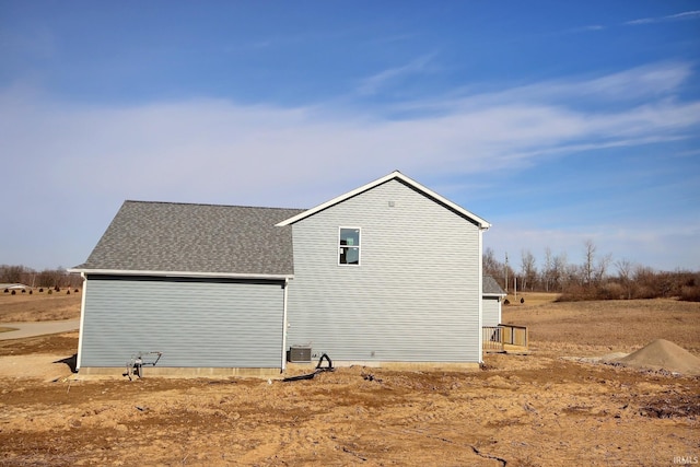 view of property exterior with central AC