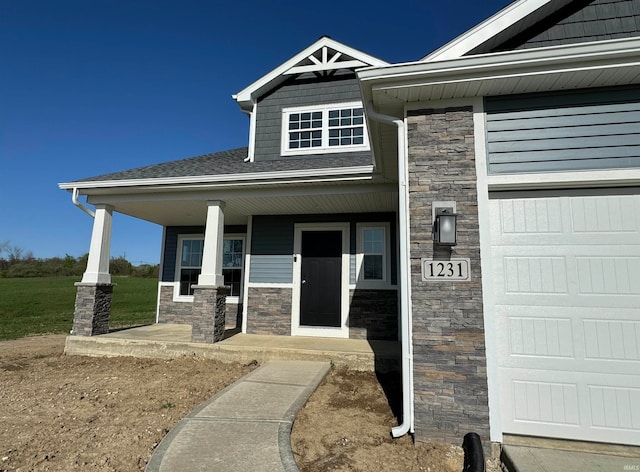 doorway to property featuring a porch and a garage