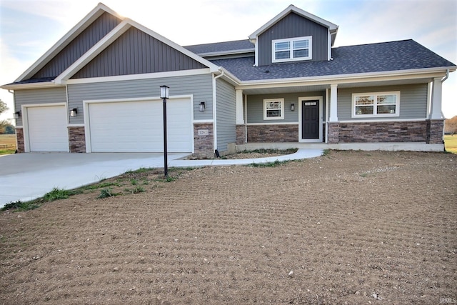 1282 Stintson Dr, Huntington, IN 46750 - craftsman house with covered porch, an attached garage, stone siding, driveway, and board and batten siding