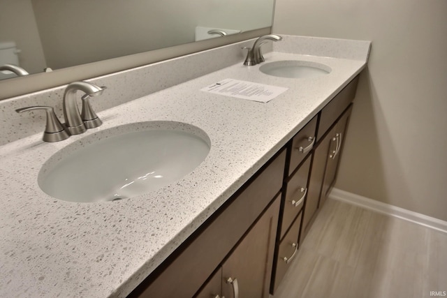 bathroom with vanity and hardwood / wood-style floors