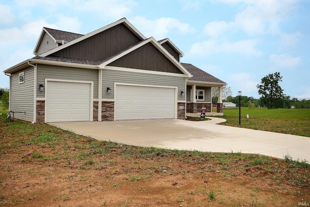 craftsman house with a front yard and a garage