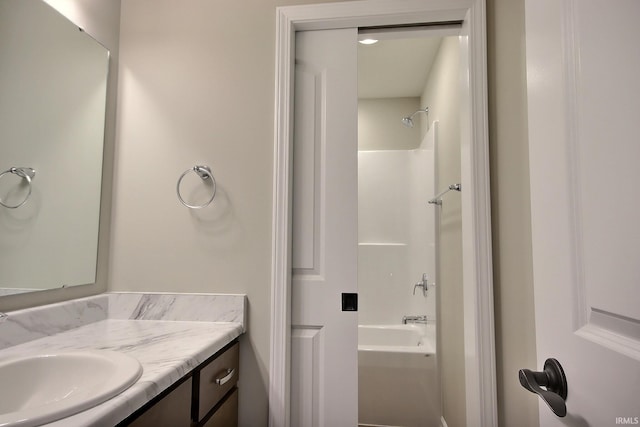 bathroom with vanity and shower / washtub combination