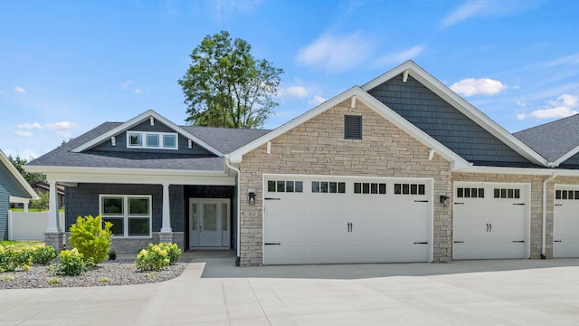 002 Ln 520 Lake James Unit 2, Fremont, IN 46737 - craftsman-style house featuring driveway, a shingled roof, stone siding, and a garage