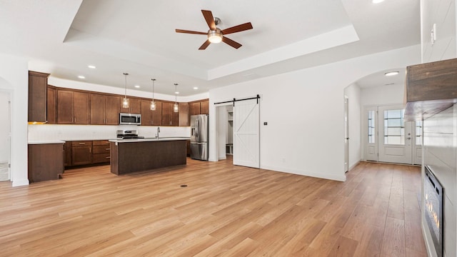 002 Ln 520 Lake James Unit 2, Fremont, IN 46737 - kitchen with light wood finished floors, stainless steel appliances, a ceiling fan, a raised ceiling, and open floor plan