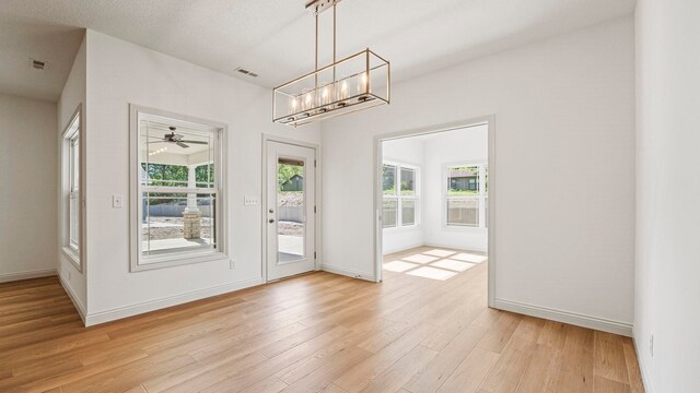 002 Ln 520 Lake James Unit 2, Fremont, IN 46737 - entryway with baseboards, light wood-type flooring, and ceiling fan with notable chandelier