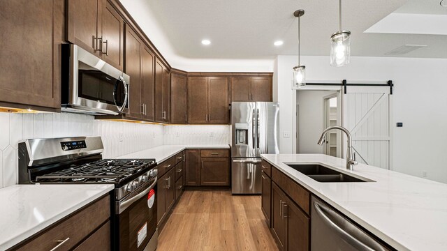 002 Ln 520 Lake James Unit 2, Fremont, IN 46737 - kitchen featuring visible vents, stainless steel appliances, dark brown cabinetry, a sink, and light wood-style floors