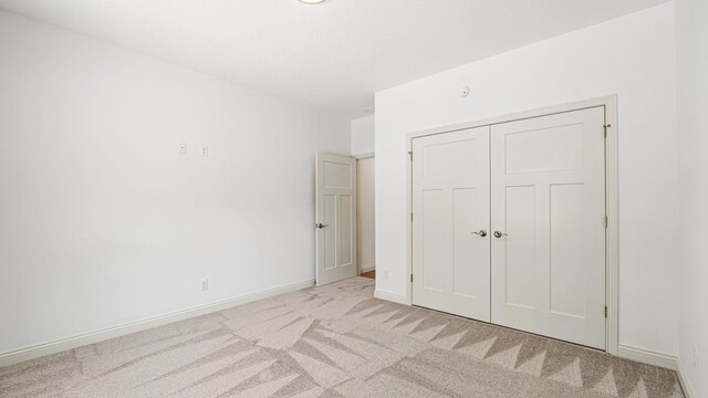 002 Ln 520 Lake James Unit 2, Fremont, IN 46737 - unfurnished bedroom with baseboards, a closet, and light colored carpet