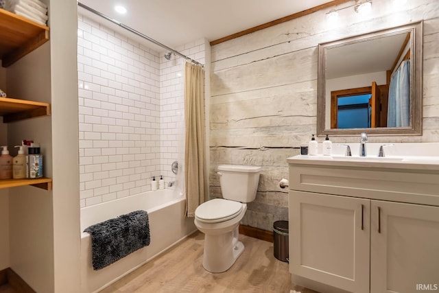 full bathroom featuring vanity, toilet, hardwood / wood-style floors, and shower / bath combination with curtain