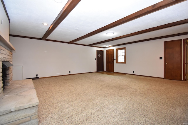 unfurnished living room featuring carpet, a fireplace, and beamed ceiling