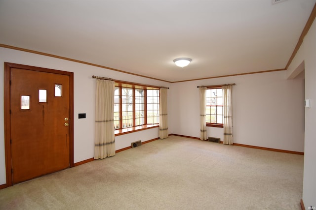 entryway featuring light colored carpet and crown molding