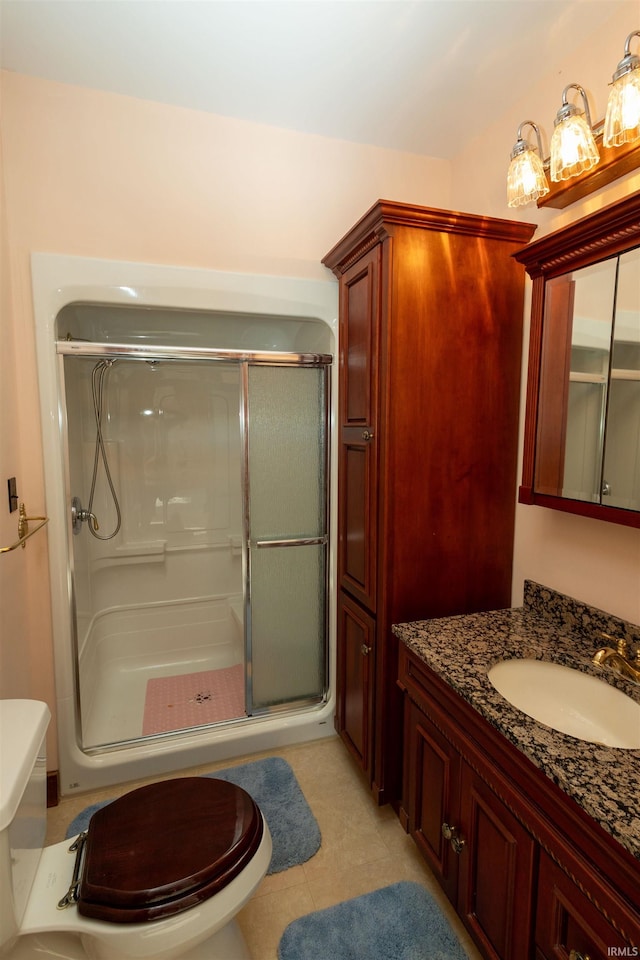 bathroom with an enclosed shower, toilet, tile flooring, and vanity