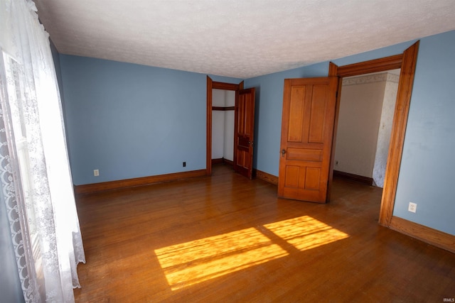 interior space featuring wood-type flooring and a textured ceiling