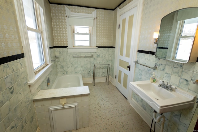 bathroom with tile walls, a bath to relax in, tasteful backsplash, and tile flooring