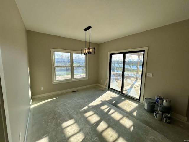 unfurnished dining area with a wealth of natural light and a chandelier