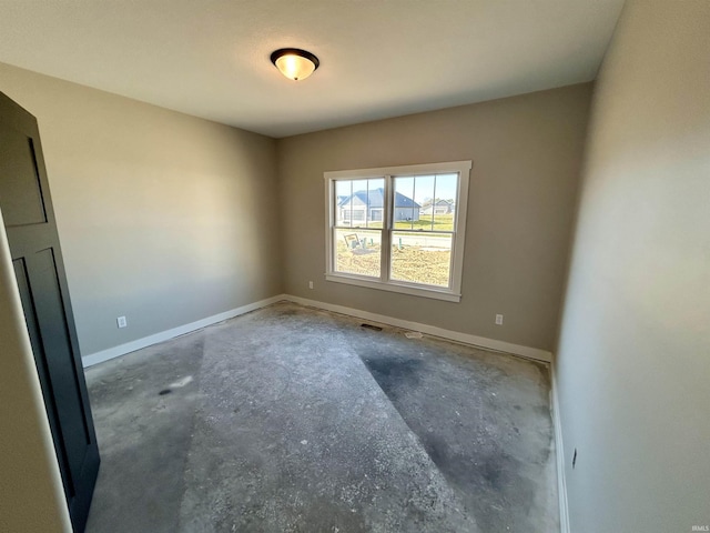 spare room with concrete floors