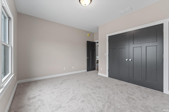 unfurnished bedroom with carpet flooring and a closet